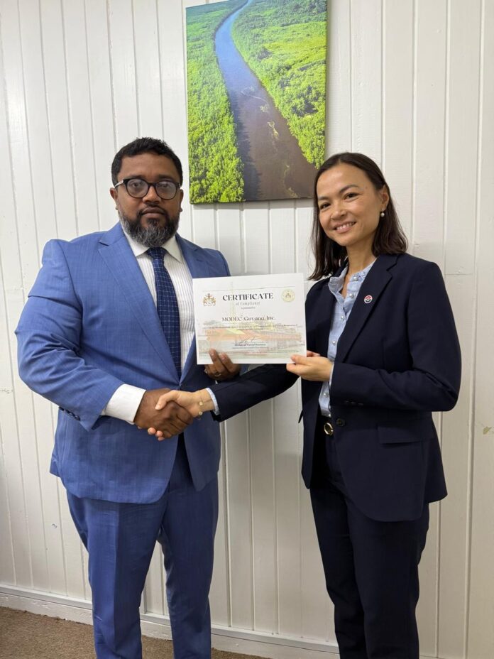 Director of Local Content Secretariat, Dr. Martin Pertab presents Letter of Approval to Corporate Manager of MODEC, Kim Huynh